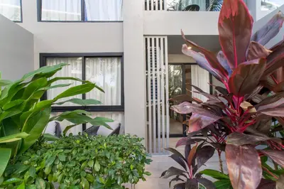 a house with a lot of plants in front of it at 1bdr Pool Access Apartment Bangtao #5103 in Bang Tao Beach