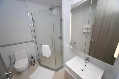 a bathroom with a shower and a toilet and a sink at 1bdr Pool Access Apartment Bangtao #5104 in Bang Tao Beach