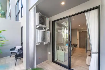 a room with a sliding glass door and a balcony at 1bdr Pool Access Apartment Bangtao #5104 in Bang Tao Beach