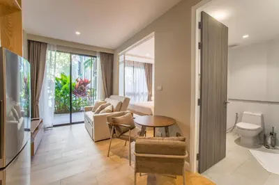 a living room with a couch and a table at 1bdr Pool Access Apartment Bangtao #5104 in Bang Tao Beach