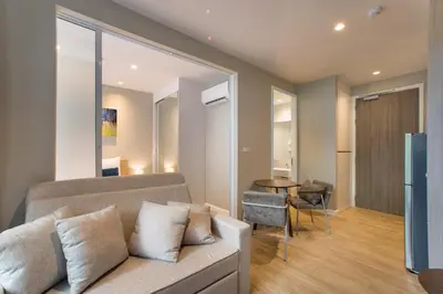 a living room with a couch and a table at 1bdr Pool Access Apartment Bangtao #5104 in Bang Tao Beach