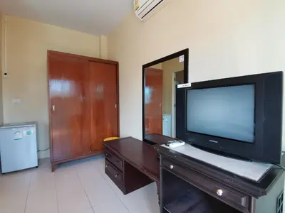 a living room with a flat screen tv on a dresser at Serene Villa Phuket in Chalong