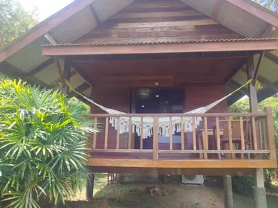 a large wooden house with a large deck at Sabai House Bungalow in Ko Yao Noi