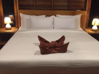 a statue of a bird sitting on a bed at Sabai House Bungalow in Ko Yao Noi