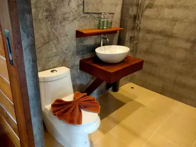 a bathroom with a bowl sink and a toilet at Sabai House Bungalow in Ko Yao Noi
