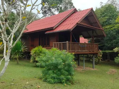 a wooden cabin with a red roof at Sabai House Bungalow in Ko Yao Noi
