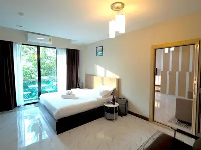 a bedroom with a bed and a large window at Pak Dee At Naithon in Nai Thon Beach