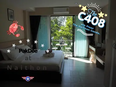a bedroom with a bed and a sign that reads at Pak Dee At Naithon in Nai Thon Beach