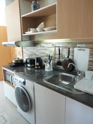 a kitchen with a sink and a washing machine at Pak Dee At Naithon in Nai Thon Beach