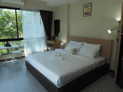 a bedroom with a bed with two teddy bears on it at Pak Dee At Naithon in Nai Thon Beach