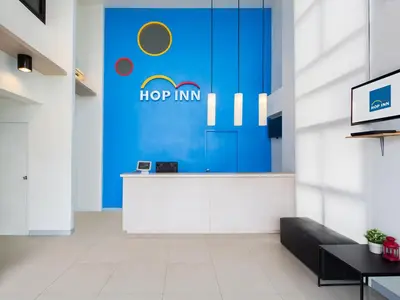 an office lobby with a hop inn sign on the wall at HOP INN Phuket Old Town in Phuket Town