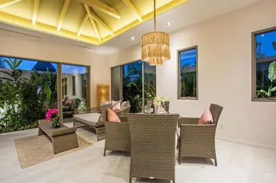 a dining room with wicker chairs and a chandelier at Boutique 2BR Pool Villa Dalaa 1, Gated Residence, Kamala Beach in Kamala Beach