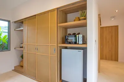 a kitchen with wooden cabinets and a refrigerator at Boutique 2BR Pool Villa Dalaa 1, Gated Residence, Kamala Beach in Kamala Beach