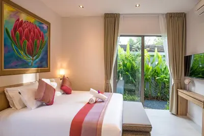 a bedroom with a bed with a large window at Boutique 2BR Pool Villa Dalaa 1, Gated Residence, Kamala Beach in Kamala Beach