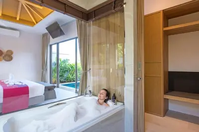 a woman laying in a bath tub in a bedroom at Boutique Resort 2BR Pool Villa Dalaa 2, Kamala Beach in Kamala Beach