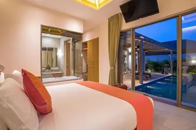 a bedroom with a large bed and a swimming pool at Luxury 2BR Pool Villa Dalaa 3, Gated Residence, Kamala Beach in Kamala Beach