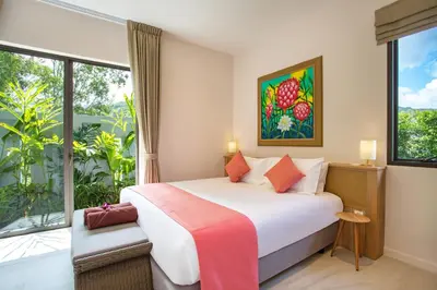 a bedroom with a bed and a large window at Luxury 2BR Pool Villa Dalaa 3, Gated Residence, Kamala Beach in Kamala Beach