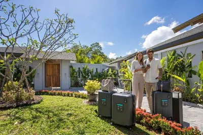a man and woman standing in front of a house with luggage at Resort Boutique 2BR Villa Dalaa 4, Private Pool, Full Service, 5 min Drive Kamala Beach in Kamala Beach