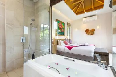 a bathroom with a tub and a bed in the background at Resort Boutique 2BR Villa Dalaa 4, Private Pool, Full Service, 5 min Drive Kamala Beach in Kamala Beach