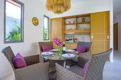 a dining room with a table and purple chairs at Resort Boutique 2BR Villa Dalaa 4, Private Pool, Full Service, 5 min Drive Kamala Beach in Kamala Beach