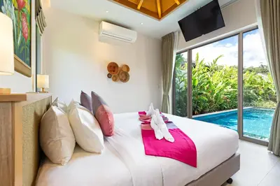 a bedroom with a large bed and a pool at Private Resort Boutique Pool Villa Dalaa 5 , near Kamala Beach in Kamala Beach