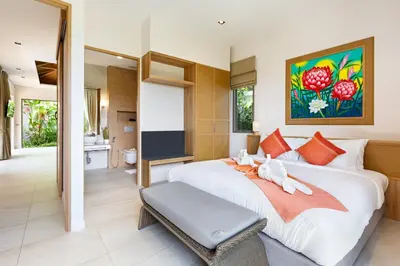 a bedroom with a large white bed and a bathroom at Private Resort Boutique Pool Villa Dalaa 5 , near Kamala Beach in Kamala Beach