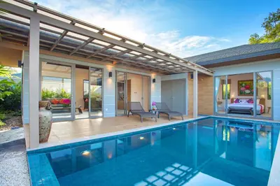 a swimming pool in front of a house at Kamala Pool Villa, Dalaa 6 in Kamala Beach