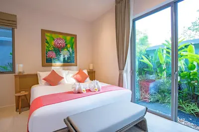 a bedroom with a bed with two teddy bears on it at Kamala Pool Villa, Dalaa 6 in Kamala Beach
