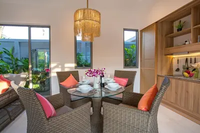 a dining room with a glass table and chairs at Kamala Pool Villa, Dalaa 6 in Kamala Beach