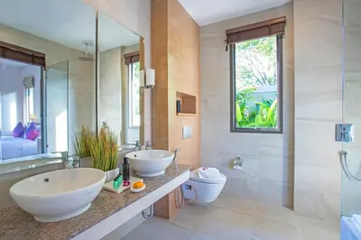 a bathroom with two sinks and a toilet at Kamala Pool Villa, Dalaa 6 in Kamala Beach