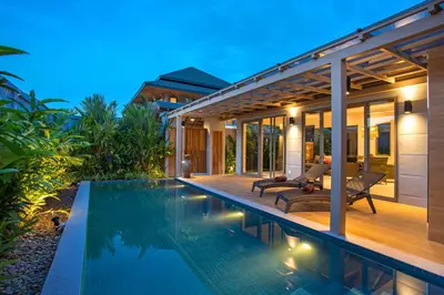 a villa with a swimming pool at night at Kamala Pool Villa, Dalaa 6 in Kamala Beach
