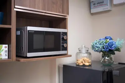 a microwave sitting on a shelf in a kitchen at NARA Condo 1BR Pool View NBC Nai Harn in Nai Harn Beach