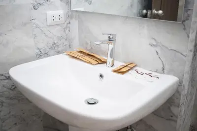 a white sink in a bathroom with marble walls at NARA Condo 1BR Pool View NBC Nai Harn in Nai Harn Beach