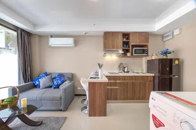 a small living room with a couch and a kitchen at NARA Condo 1BR Pool View NBC Nai Harn in Nai Harn Beach