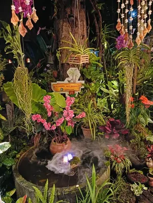 a garden with a pond with flowers and plants at P P Garden Home Bungalow in Phi Phi Don