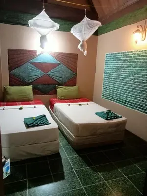 two beds sitting in a room with two lamps at P P Garden Home Bungalow in Phi Phi Don