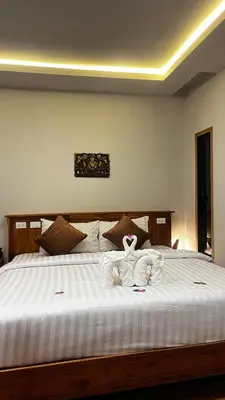 a bedroom with a large white bed with towels on it at KLONGBON GARDEN HOME Koh Yao Yai in Ko Yao Yai
