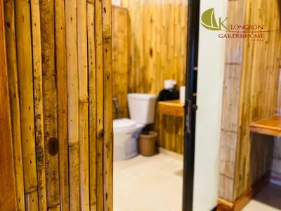 a bathroom with wooden walls and a toilet at KLONGBON GARDEN HOME Koh Yao Yai in Ko Yao Yai