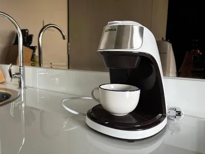 a coffee maker sitting on a counter with a cup at Aristo Resort Surin Beach K02 in Surin Beach