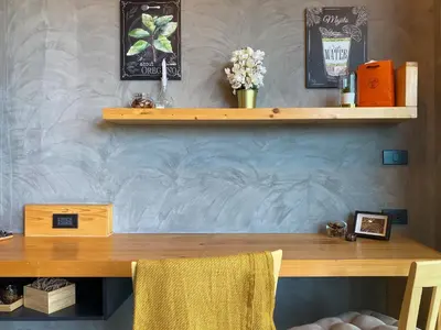a wooden table with two chairs in a room at ReLife Windy Naiharn by Beringela in Nai Harn Beach