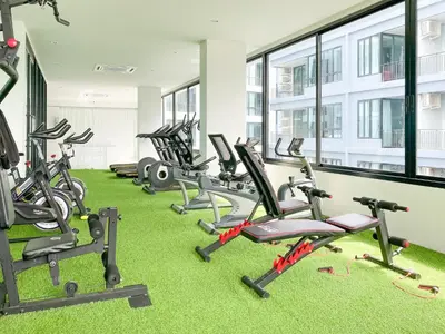 a row of exercise bikes in a gym at ReLife Windy Naiharn by Beringela in Nai Harn Beach