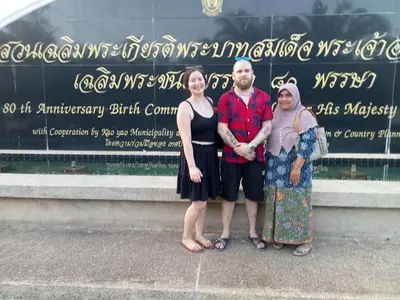 a group of three people standing in front of a sign at Baan Kebsap บ้านเก็บทรัพย์ in Ko Yao Noi