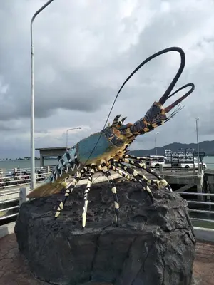 a statue of a bug on a rock at Baan Kebsap บ้านเก็บทรัพย์ in Ko Yao Noi