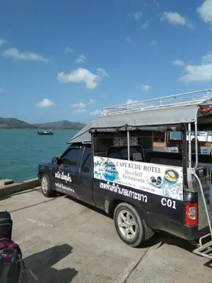a black truck parked next to a boat at Baan Kebsap บ้านเก็บทรัพย์ in Ko Yao Noi