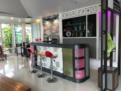 a bar with colorful stools in a room at Cafe'@luv22 in Phuket Town