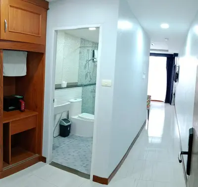 a bathroom with a tub and a toilet and a sink at La Capannina Hotel Patong in Patong Beach