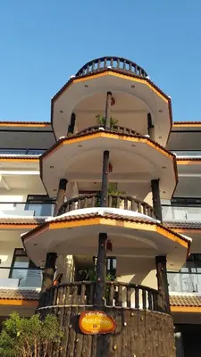 a building with a balcony on the side of it at La Capannina Hotel Patong in Patong Beach