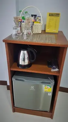 a shelf with a coffee maker on top of a desk at La Capannina Hotel Patong in Patong Beach