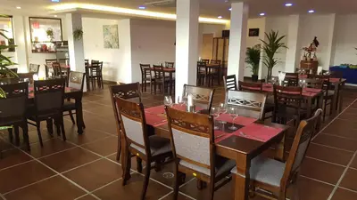 a dining room with tables and chairs in a restaurant at La Capannina Hotel Patong in Patong Beach