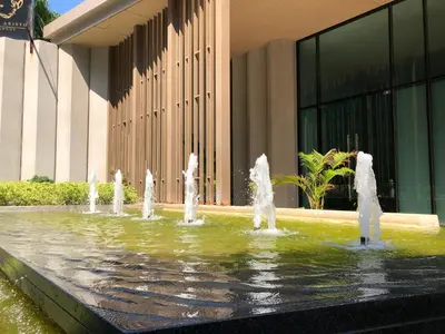 a water fountain in front of a building at Aristo Resort Surin Beach J16 in Phuket Town